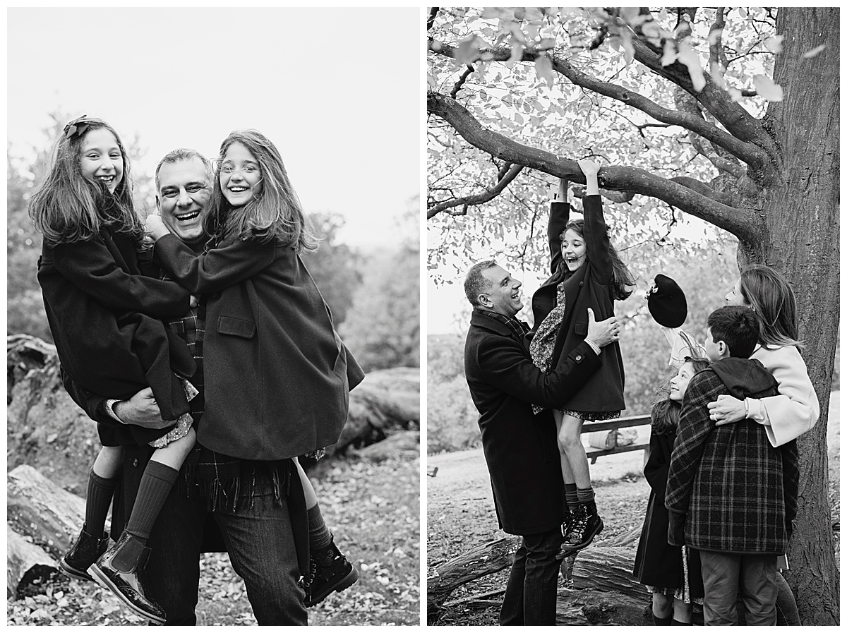 Black and white image of a family having fun, hanging from a tree in Richmond Park
