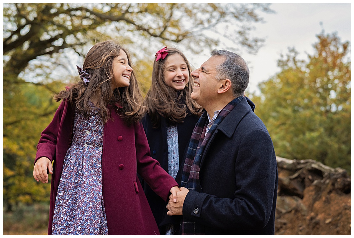 Image of a young family in Richmond Park wearing beautiful coats. This image is to give readers some Autumn Photoshoot Outfit Ideas