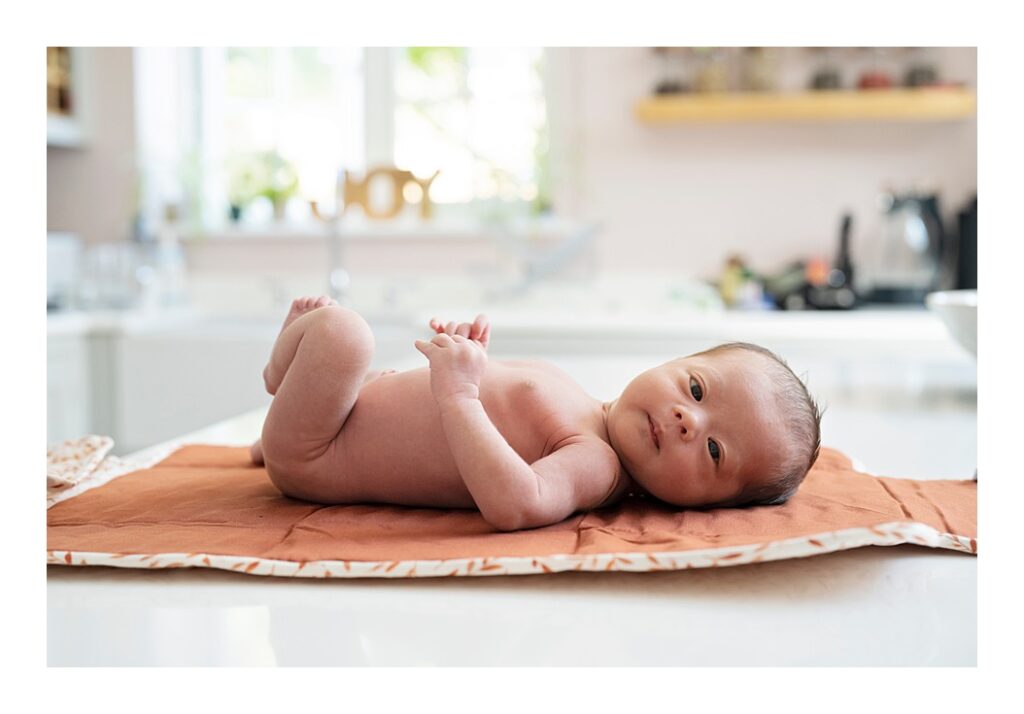 Newborn baby girl on her change mat